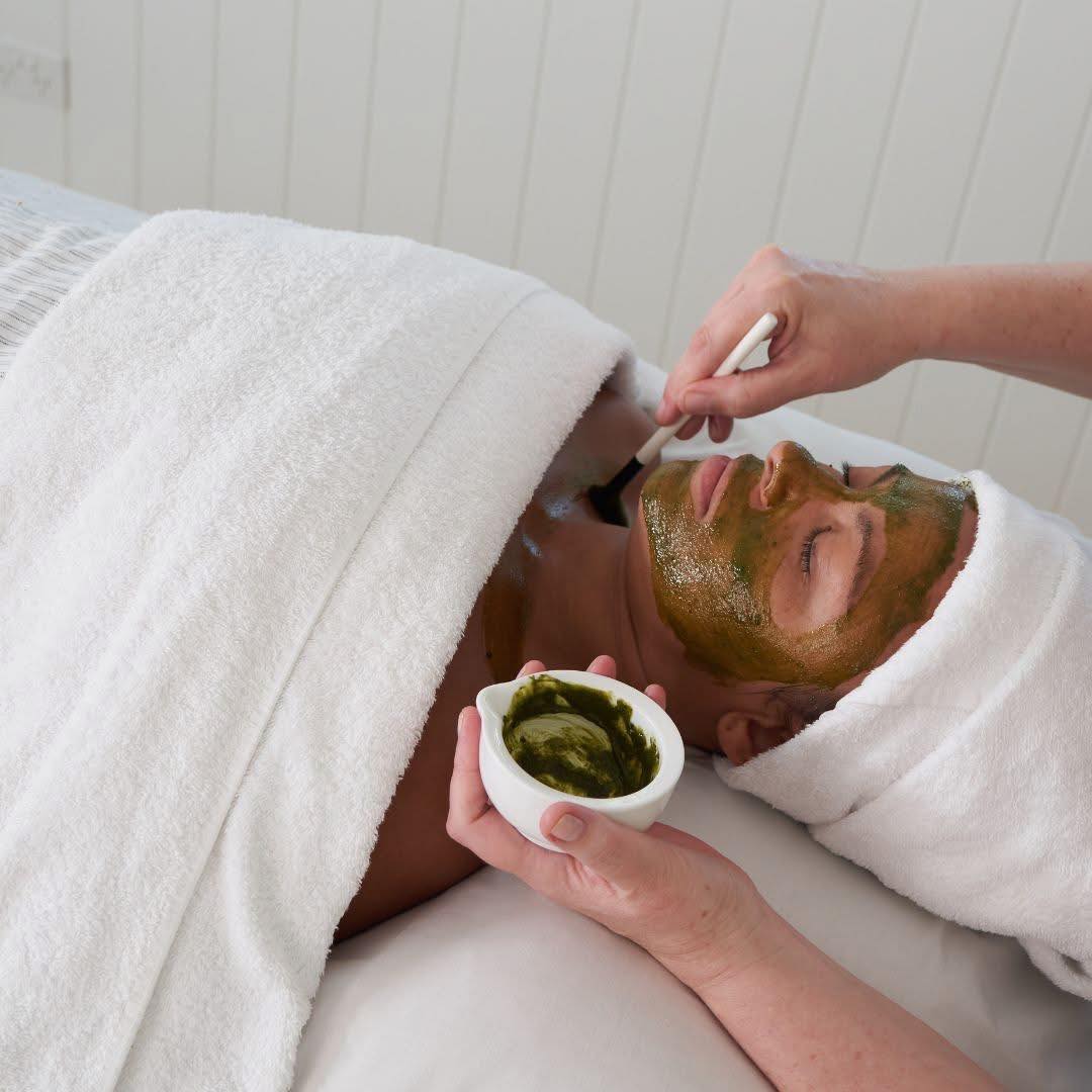 Woman Applying Facial Mask on Client — Selenas Beauty Studio in Petrie, QLD